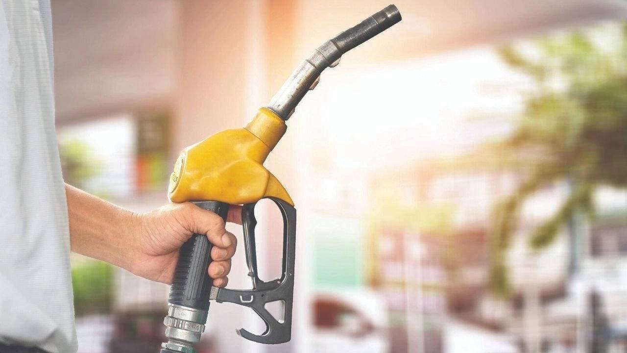 Benzin istasyonunda yakıt pompası ile dolum yapan bir otomobilin görüntüsü.